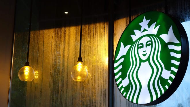 File photo taken in 2015 shows a Starbucks logo in one of the coffee  company's cafes in Washington, DC.