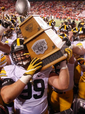 Iowa defensive lineman Nathan Bazata carries the Heroes Game trophy after Iowa beat Nebraska, 56-14, on Friday, Nov. 24, 2017, at Memorial Stadium in Lincoln, Neb.
