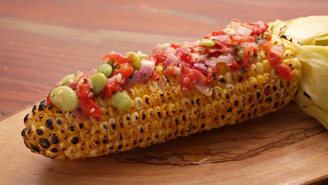 Grilled corn on the cob with succotash confetti butter by chef Bryan Dooley.