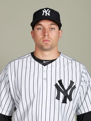 New York Yankees outfielder Jake Cave (93) poses on photo day at George M. Steinbrenner Field in February.