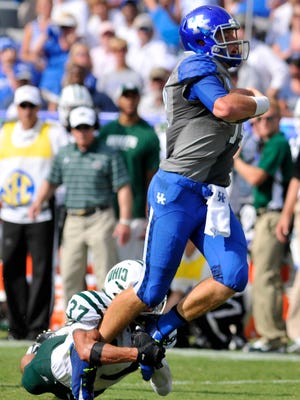 UK's Patrick Towels rushes against Ohio in the first half, Saturday, Sept. 06, 2014, at Commonwealth Stadium in Lexington. Towles ran 13 times for 46 yards in the first half.
