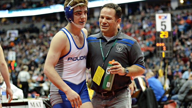 Poudre High School coach Barrett Golyer congratulates Jacob Greenwood on winning a semifinal match at the state wrestling tournament on Friday at Pepsi Center.