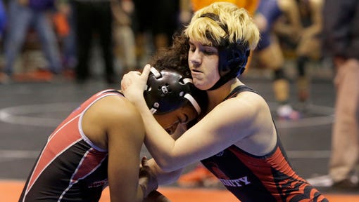 Mack Beggs, right, a transgender wrestler from Euless Trinity competes in a quarterfinal against Mya Engert of Amarillo Tascosa during the state wrestling tournament Friday, Feb. 24, 2017, in Cypress, Texas. Beggs was born a female and is transitioning to male but wrestles in the girls division.