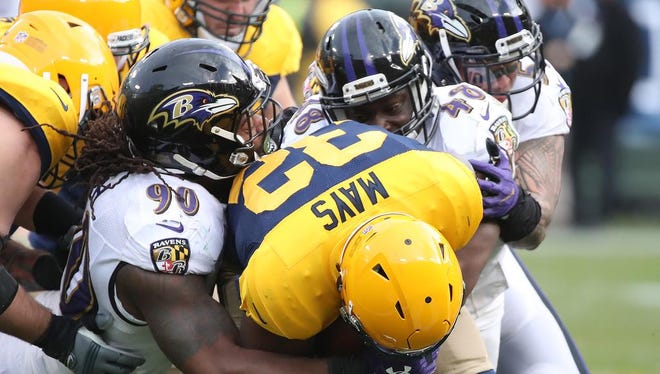Green Bay Packers running back Devante Mays (32) drags tacklers against the Baltimore Ravens Sunday, November 19, 2017 at Lambeau Field in Green Bay, Wis.