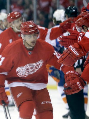 Detroit Red Wings left wing Tomas Tatar (21) is congratulated by teammates after his goal during the first period of an NHL hockey game against the New York Islanders, Saturday, Jan. 31, 2015, in Detroit.