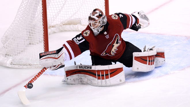 Nov 24, 2017; Glendale, AZ, USA; Arizona Coyotes goalie Scott Wedgewood (31) makes a save against the Los Angeles Kings during the first period at Gila River Arena. Mandatory Credit: Joe Camporeale-USA TODAY Sports