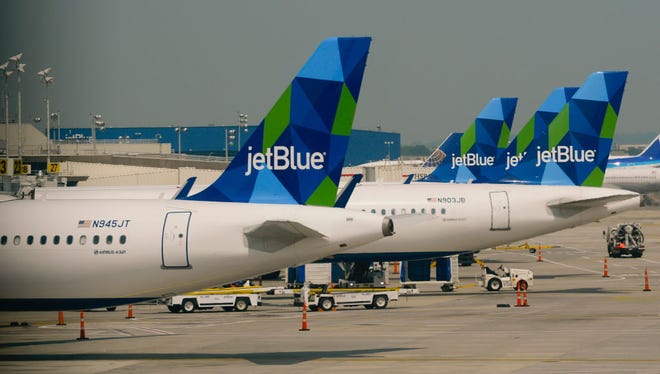 Jet Blue planes at gates at New York's John F. Kennedy airport on June 11, 2015.