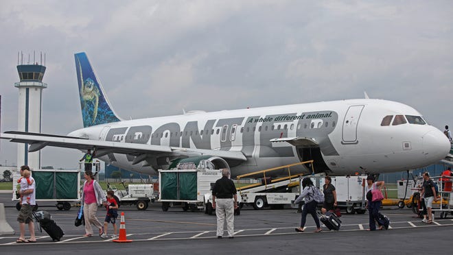 
Passengers get off a Frontier plane at New Castle County Airport. 
