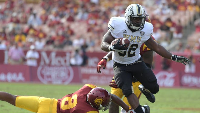 Western Michigan Broncos running back Jamauri Bogan (32) is defended by Southern California Trojans defensive back Iman Marshall (8) during a NCAA football game at Los Angeles Memorial Coliseum. USC defeated Western Michigan 49-31.