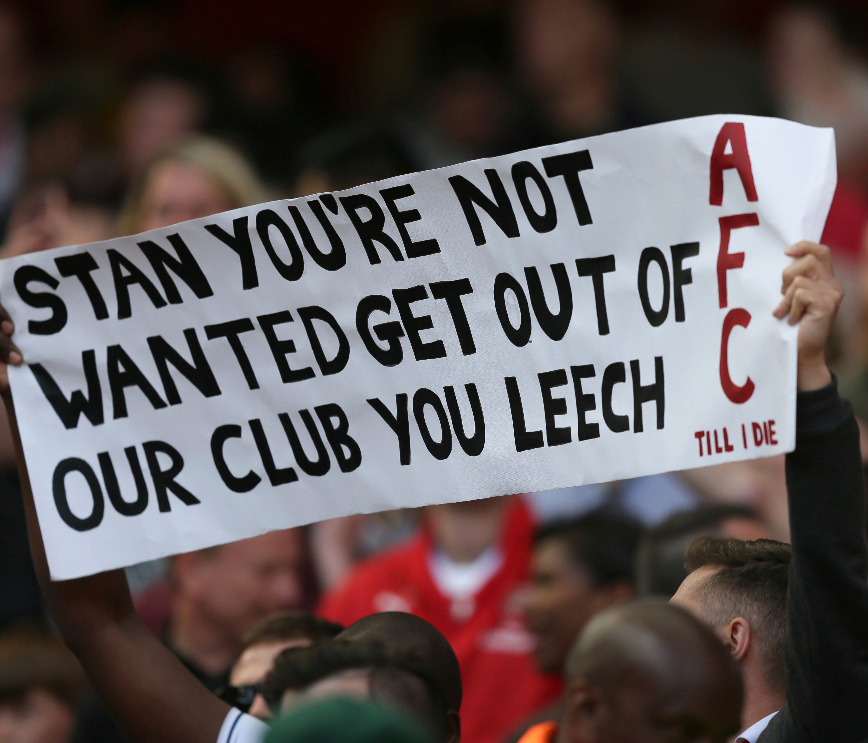 An Arsenal fan holds up a protest banner in reference to Arsenal majority owner Stan Kroenke, during the English Premier League soccer match between Arsenal and Everton at The Emirates stadium in London, Sunday May 21, 2017. (AP Photo/Tim Ireland)