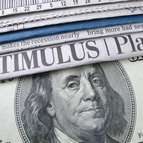 Newspaper headlines about a stimulus plan and a $1