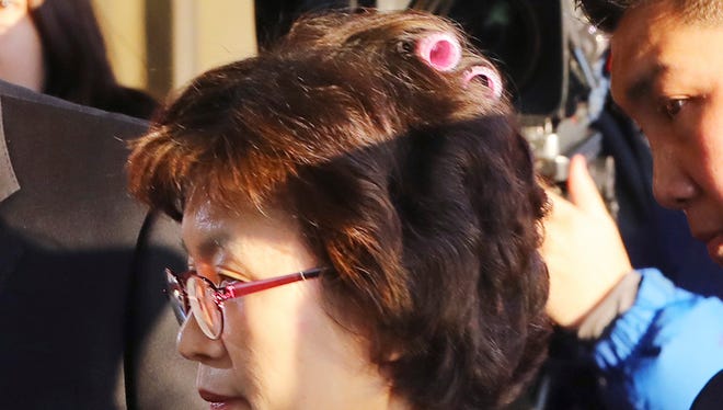 Acting Chief Justice Lee Jung-mi arrives with curlers in her hair at the Constitutional Court in Seoul, South Korea, Friday, March 10, 2017.  In a historic, unanimous ruling Friday, South Korea's Constitutional Court formally removed impeached President Park Geun-hye from office over a corruption scandal that has plunged the country into political turmoil and worsened an already-serious national divide. (Kim Ju-sung/Yonhap via AP) KOREA OUT
