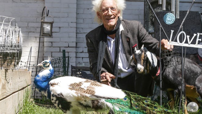 Bill Levin, shown here in 2015 with his peacock Bert and one of his goats at his Indianapolis home just south of the Indiana State Fairgrounds. Levin said Bert was found murdered on Aug. 23.