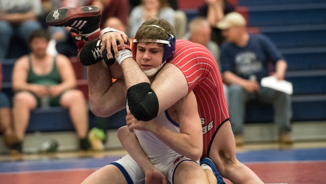 Spring Grove's Chase Bricker, left, wrestles for a takedown with Bermudian Springs' Landon West, during the YAIAA senior all star wrestling match, hosted by the Greater York Wrestling Officials Association at Spring Grove High School, Tuesday, March 13, 2018. The officials association also gave away two $500 scholarships, awarded to Gettysburg's Joseph Pecaitis and Spring Grove's Trent Baker. 