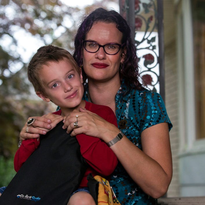 Photo shows Maya Rockafellow, 40, and her 6-year-old son, Graham Rockafellow with  Graham's new backpack and bulletproof backpack insert as the first-grade student prepares for returning to school for the 2018-2019 education year.