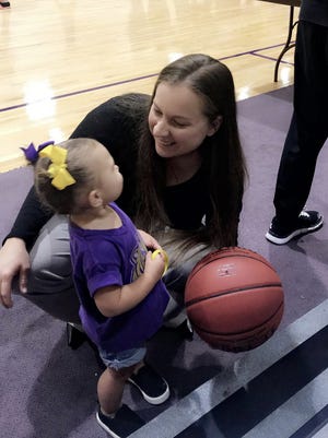 Joanna Tate, here visiting with the child of a friend, has been hired as the girls basketball coach at Byrd.