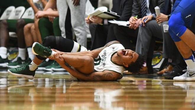 Prentiss Nixon, CSU's leading scorer, grimaces while grabbing his injured ankle during the final seconds of Wednesday night's loss to Air Force at Moby Arena. Nixon, the Rams' leading scorer, was on crutches in the locker room after the game, coach Larry Eustachy said, and will likely miss Saturday's game against UNLV and possibly others.