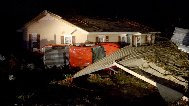 A truck was turned on its side against a house on Falcon Road in Selmer, Wednesday evening as storms passed through the area.