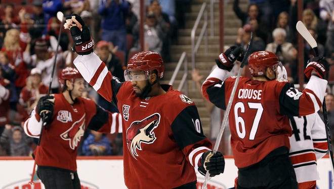 Arizona Coyotes winger Anthony Duclair (10) celebrates his assist on a goal by teammate Peter Holland during the second period of an NHL hockey game against the Carolina Hurricanes, Sunday, March 5, 2017, in Glendale, Ariz.