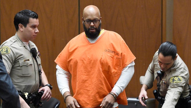 Marion "Suge" Knight, center, arrives in court for a hearing about evidence in his murder case, in Los Angeles on March 9, 2015.