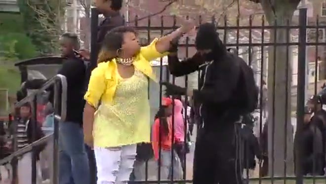 In an image taken from video, a woman later identified as Toya Graham wrangles her son after she found out that he was rioting in Baltimore on Monday.