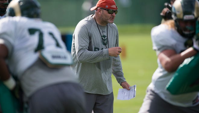 CSU offensive coordinator Will Friend instructs the offensive line during practice Wednesday, August 10, 2016. 