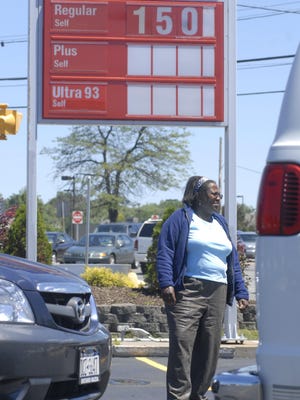 RocRoots looks back: Customer Selma Perry of Rochester, pictured at the pumps at the Sunoco station at Long Pond Road and Ridgeway Avenue in Greece on July 10, 2008. Today, the station is the last remaining in the old “Gasoliine Alley.”