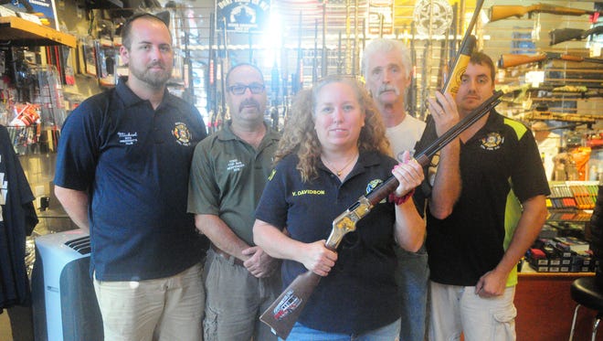 The winner of the Roxana Fire Company gun raffle, Virginia Davidson, with Roxana's Mike Magee, Todd Marvel and Michael Kaiser, and Main Street Trader's Doug Helfer.
