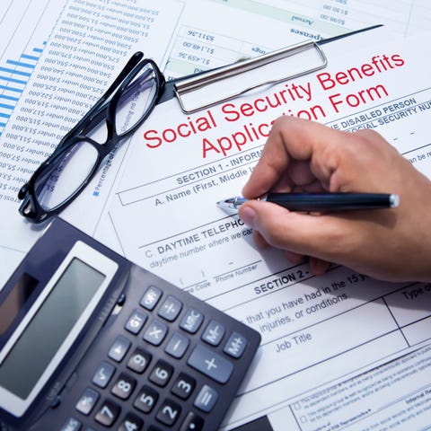 A person filling out a Social Security benefits ap