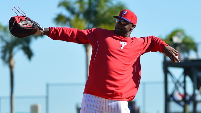 First baseman Ryan Howard throws home under sunny skies in Clearwater in March 2014.