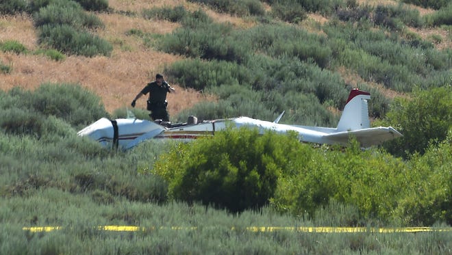 Authorities inspect the crash of a small airplane near the Truckee/Tahoe Airport on July 17, 2018. 