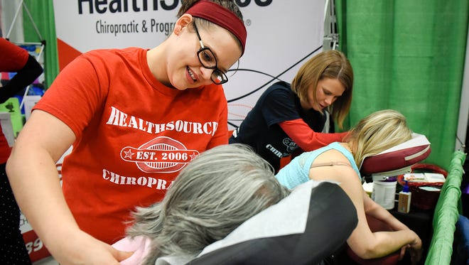 Rehab specialists Porsche Krast, left, and Sara Johnson, HealthSource Chiropractic, give massages during the Wellness Expo on Saturday, March 5, at the River's Edge Convention Center.