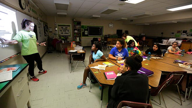 Girls on Run coach Gillian King talks Tuesday with Woodworth Middle School students during a program meeting.