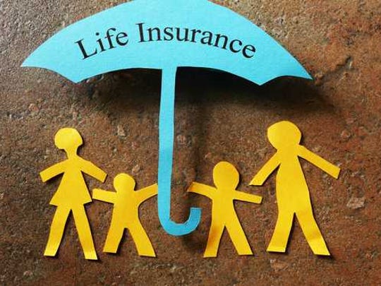 A paper cutout family under an umbrella that reads