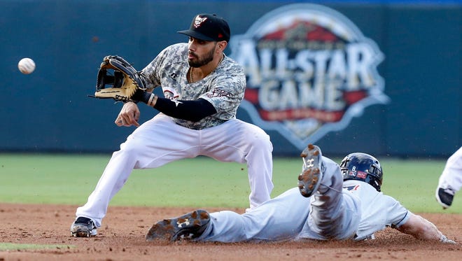 Chihuahuas second baseman Carlso Asuaje looks the ball into his glove during a steal attempt by Colorado Springs right fielder Brett Phillips, Phillips got the jump and made it safely to second base.