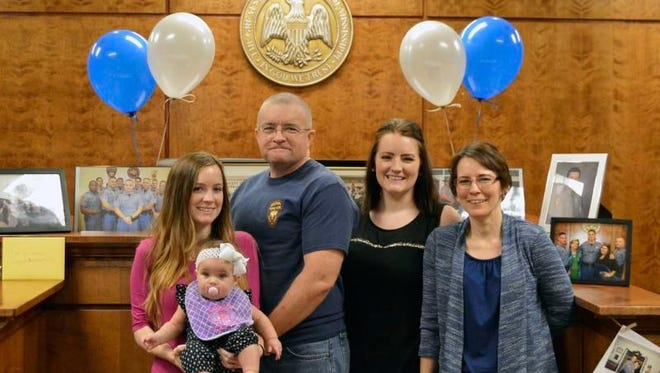 Mississippi Highway Patrol Trooper Joe Johnson stands with family following an informal retirement party for him in Picayune, Miss. Johnson retired from the force after 29 and a half years on the road.