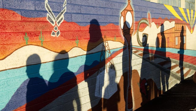 Foster care children celebrate at the unveiling ceremony of the Free Arts community mural, hosted by Free Arts for Abused Children of Arizona at Desert Rose Pizza and Gastropub in Glendale on Sunday, Nov. 29, 2015.