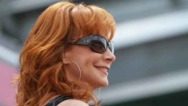 Reba McEntire performs "America The Beautiful" during the opening ceremonies of the Brickyard 400, July 31, 2011.