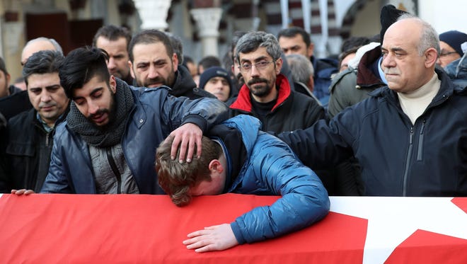 Relatives and friends mourn at the coffin during the funeral of Ayhan Arik, one of the 39 victims of the gun attack on the Reina, a popular night club in Istanbul on Jan. 1, 2017.