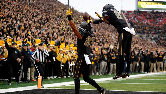 Iowa tight end Noah Fant (87) celebrates with teammate Ihmir Smith-Marsette after catching a 3-yard touchdown pass during the first half against No. 3 Ohio State on Saturday.