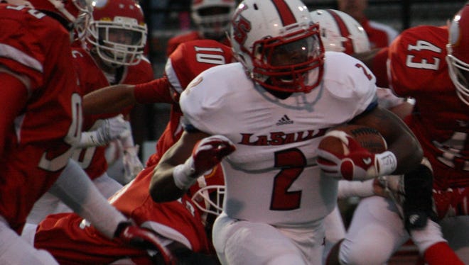 La Salle sophomore Jarell White breaks through a gang of Princeton Vikings in the first quarter of their game Sept. 12, 2014 at Princeton High School.