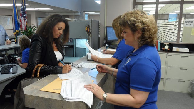 Vivian Ebare Brossett (left) files paperwork Thursday to run for the House District 25 seat currently held by Lance Harris. Helping her is Rapides Parish Clerk of Court Robin Hooter (right), who was re-elected without opposition.