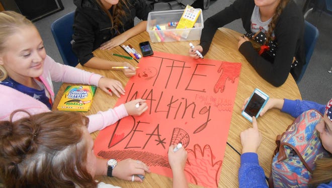 Virgin Valley FFA members, from left to right, Peyton Hafen, Falen Hafen, Shaina Buccicardi, Emily Leavitt and Shalle Hafen, prepare a poster for the FFA Haunted Hayride.