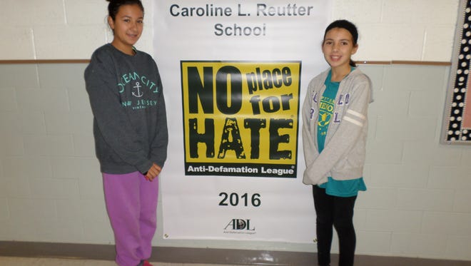 The Caroline L. Reutter School was named a "No Place For Hate Award School" for its ongoing, research-based character development initiative. Mya Cope, president, Student Council, and Kaylee Bowman, vice president, Student Council, pose with the banner announcing this honor.