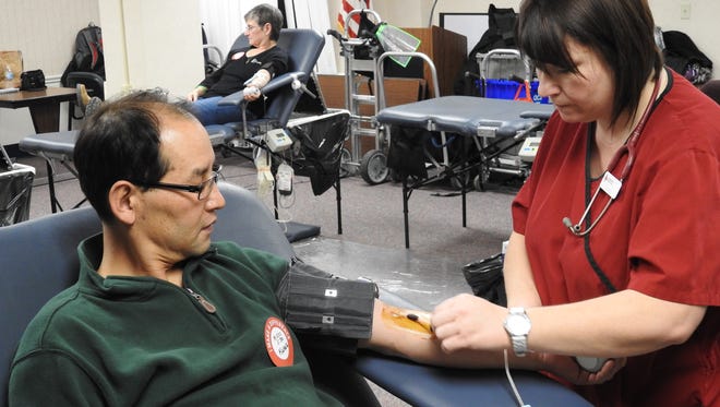 Kwang Song, of Coshocton, donated blood through the Red Cross last week at the Coshocton Regional Medical Center with the help of phlebotomist Julie Snyder.