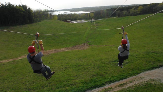 Zip-liners race down a dual line at Lake Geneva Canopy Tours.