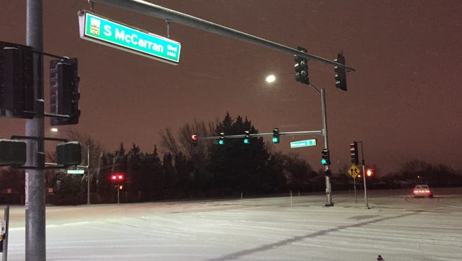 Snow falls in southeast Reno at McCarran Boulevard and Mira Loma Drive.