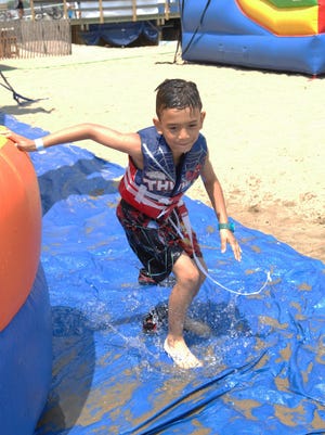 The Borough of Belmar hosted Military Appreciation Day on July 19, 2015. The event featured free beach addmission food, refreshments and amusements for armed forces members and their families. Jayden Peres (7) of Staten Island enjoys the event at Belmar's Fifth Ave. beach.