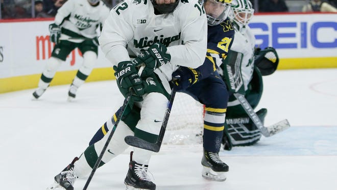 Michigan State defenseman Tommy Miller (12), shown last weekend against Michigan, scored a goal in the Spartans' 5-3 win over Penn State on Friday night. (AP Photo/Duane Burleson)