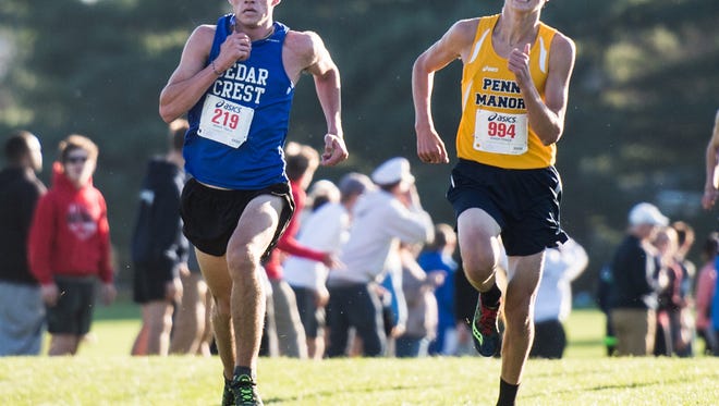 Cedar Crest's Jake Barrett fights past Penn Manor's Nicholas Fafel in the final stretch at the Lancaster-Lebanon League cross country meet on Tuesday, Oct. 17, 2017. 